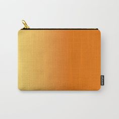 an orange and yellow color carry - all pouch with gold hardware on the front side