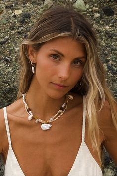 A beach-inspired accessory crafted with brown sea glass, pearls, and natural shells. The 25mm baroque pearl drop adds a touch of elegance. Adjustable length of 14-17" for the perfect fit. Embrace your beach vibes with this unique necklace! Length: 14”-17” Crafted with 14K Gold Filled Chain and Brown Seaglass, pearls, natural shells, and a 25mm baroque pearl drop. Handmade with love from San Clemente, CA. Part of the Taylor Hayden Collection. Beach Pearl Chain Shell Necklace, Summer Beach Pearl Shell Necklace, Bohemian Baroque Pearl Beaded Necklace, White Pearl Necklace With Pearl Pendant For Beach, Summer Beach Pearl Necklace With Pearl Charm, Beach Baroque Pearl Jewelry With Pearl Charm, Bohemian Pearl Necklace For Beach, Bohemian Pearl Necklace For Vacation, Bohemian Style Pearl Chain Necklace For Beach