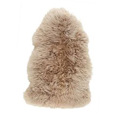 a sheepskin rug is shown on a white background, with the fur covering it's back