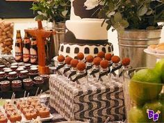 a table topped with lots of desserts and cupcakes