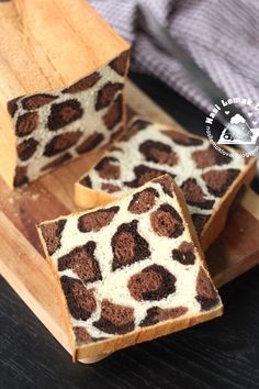 two slices of cake sitting on top of a wooden cutting board