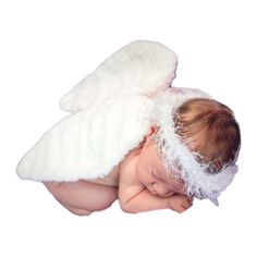 a baby is sleeping with an angel wings on it's head