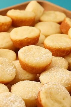 a close up of some small pastries in a pan on a table with blue background