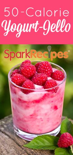 yogurt jello with raspberries in a small glass on a wooden table