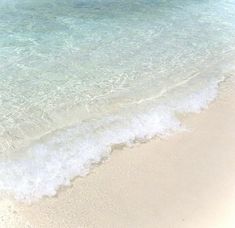 an ocean beach with waves coming in to the shore