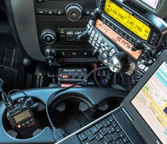 a laptop computer sitting on top of a car dashboard