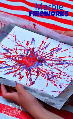 someone is painting with red, white and blue paint on a piece of paper that says marble fireworks