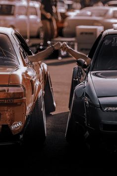 two cars parked next to each other in a parking lot