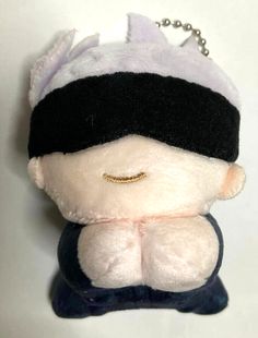 a small stuffed animal with a blindfold on it's head and eyes closed