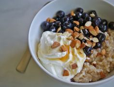 a bowl filled with oatmeal, raisins and blueberries