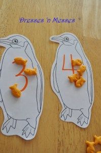 two penguins with numbers cut out to make them look like birds