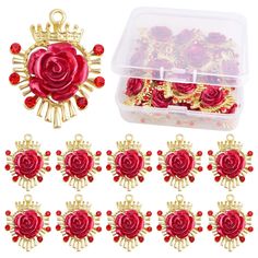 red roses and gold charms in a plastic container with lots of other items around it