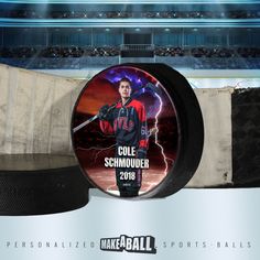 a hockey puck with the image of cole schnoufer on it in front of an arena