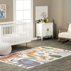 a baby's room with a white crib, rocking chair and rug on the floor