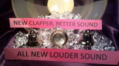 there are three bells on top of each other and one has a pink sign that says new clapper, better sound all new loud