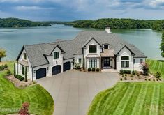 this is an aerial view of a large house in the middle of a beautiful lake