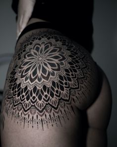 the back of a woman's body with tattoos on it