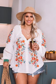 Plus Size - Dress for spring in our darling white 'Dune Dreaming' top featuring lightweight material with gorgeous blue, green, and red/orange hued embroidered floral detailing, a v-cut neckline with a tie closure, long loose sleeves with elastic band cuffs, and a relaxed silhouette that falls into a straight hemline! Measurements 1XL : Bust 50", Hip 52", Length 25", Sleeve Length 25.5", Waist 51". 2XL : Bust 52", Hip 54", Length 26", Sleeve Length 26", Waist 53". 3XL : Bust 54", Hip 56", Length Spring Vacation Embroidered Top With Embroidered Neckline, Spring Vacation Embroidered Neckline Top, Floral Embroidered V-neck Top For Brunch, V-neck Tops With Floral Embroidery For Brunch, V-neck Top With Floral Embroidery For Brunch, Casual V-neck Embroidered Top With Floral Print, Casual V-neck Floral Print Embroidered Top, Multicolor Embroidered V-neck Blouse, V-neck Blouse With Multicolor Embroidery For Vacation