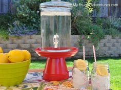 a table with lemons and mason jars on it