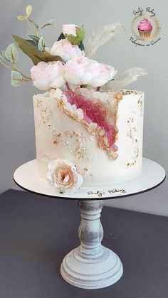 a white cake with pink flowers on top