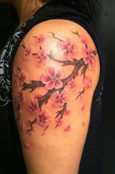 a woman's arm with pink flowers on it