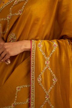 Editor's Note A mustard yellow zardozi embroidered dupion silk sari and blouse would be a stunning choice for a traditional event or wedding. The rich and vibrant color paired with intricate zardozi embroidery would make for a gorgeous and elegant ensemble. Color: Mustard yellow Fabric: Dupion silk & chanderi Embroidery details: Zardozi embroidery Components: Sari & blouse Sari length: 6 meters, sari width: 46" inches Occasion: Festive and Wedding Guest Disclaimer: Product color may slightly var Designer Embroidered Gold Pre-draped Saree, Designer Gold Embroidered Pre-draped Saree, Chanderi Pre-draped Saree With Intricate Embroidery, Gold Embroidered Art Silk Pre-draped Saree, Gold Raw Silk Sets With Intricate Embroidery, Gold Sets With Intricate Embroidery In Raw Silk, Festive Pre-draped Raw Silk Saree With Intricate Embroidery, Bollywood Style Dori Work Pre-draped Saree In Dola Silk, Festive Bollywood Pre-draped Tussar Silk Saree