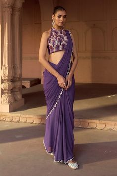 Purple sleeveless halter neck padded blouse with all over persian mural art embroidery using beads, cut dana, sequins highlights. Paired with a scallop border pre-draped saree in georgette base. - Aza Fashions Elegant Fitted Pre-draped Saree For Summer, Elegant Summer Pre-draped Fitted Saree, Fitted Sleeveless Pre-draped Saree For Reception, Elegant Fitted Sleeveless Pre-draped Saree, Summer Fitted Pre-draped Saree, Sleeveless Pre-draped Saree For Party, Fitted Sleeveless Pre-draped Saree For Festive Occasions, Fitted Sleeveless Pre-draped Saree For Festive Season, Unique Designer Dresses Indian