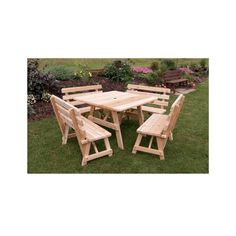 a wooden table and chairs in the grass