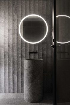 a bathroom with a round mirror on the wall