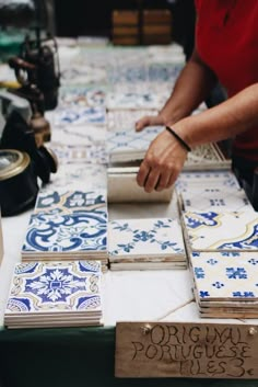 a table with blue and white tiles on it, including one that says origami portuguese tiles