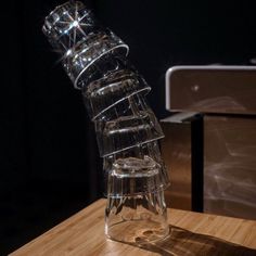 a clear glass vase sitting on top of a wooden table