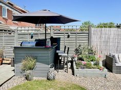 an outdoor kitchen and patio area in a back yard