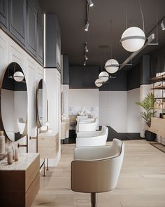 the interior of a hair salon with chairs, mirrors and lights hanging from the ceiling