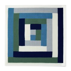 a rug with blue, green and white squares on the bottom half of it's square shape