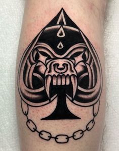 a black and white tattoo on the leg of a man