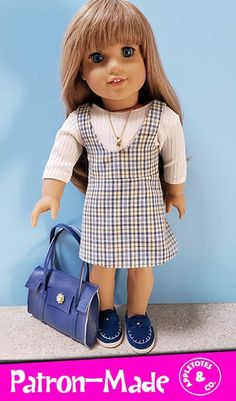 a doll is standing next to a purse