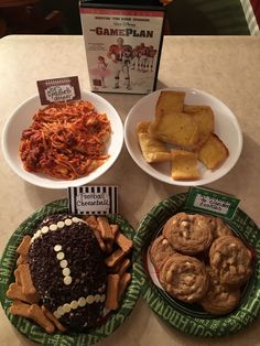 three plates filled with food sitting on top of a table next to a box of crackers