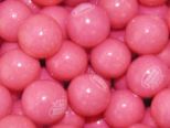 some pink candy balls are stacked up together