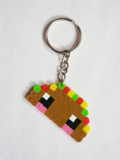 a keychain made to look like a dog with beads on it's face