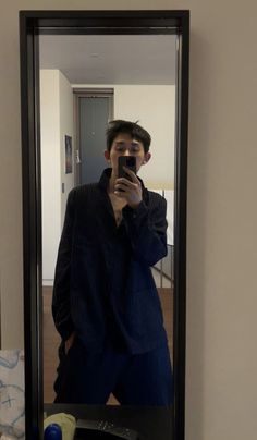 a man taking a selfie in front of a mirror