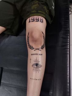 a person with a tattoo on their arm that has an eye and cross in it