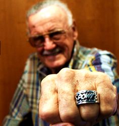 an older man is pointing his finger at the camera while wearing a ring that says happy birthday