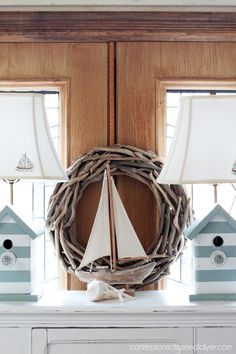 a wreath with sailboats and bird houses on it