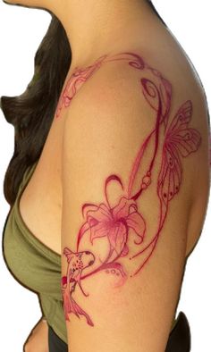 a woman's breast with flowers and butterflies on her left side, which is covered in pink ink