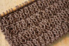 a brown knitted cloth on top of a wooden table