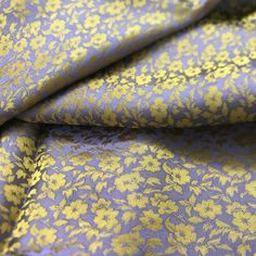 a blue and yellow fabric with flowers on it