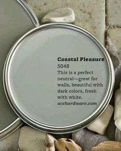 there is a tin with some white paint on it and the words coastal pleasure written in black