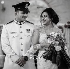 a bride and groom smile as they walk down the aisle