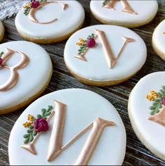 decorated cookies with letters and flowers on them