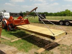 a tractor trailer with a wooden ramp attached to it